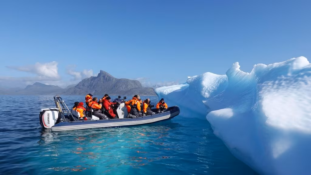 A bowhead whale swimming near ice floes in the Arctic Ocean, illustrating its long-lived habitat.