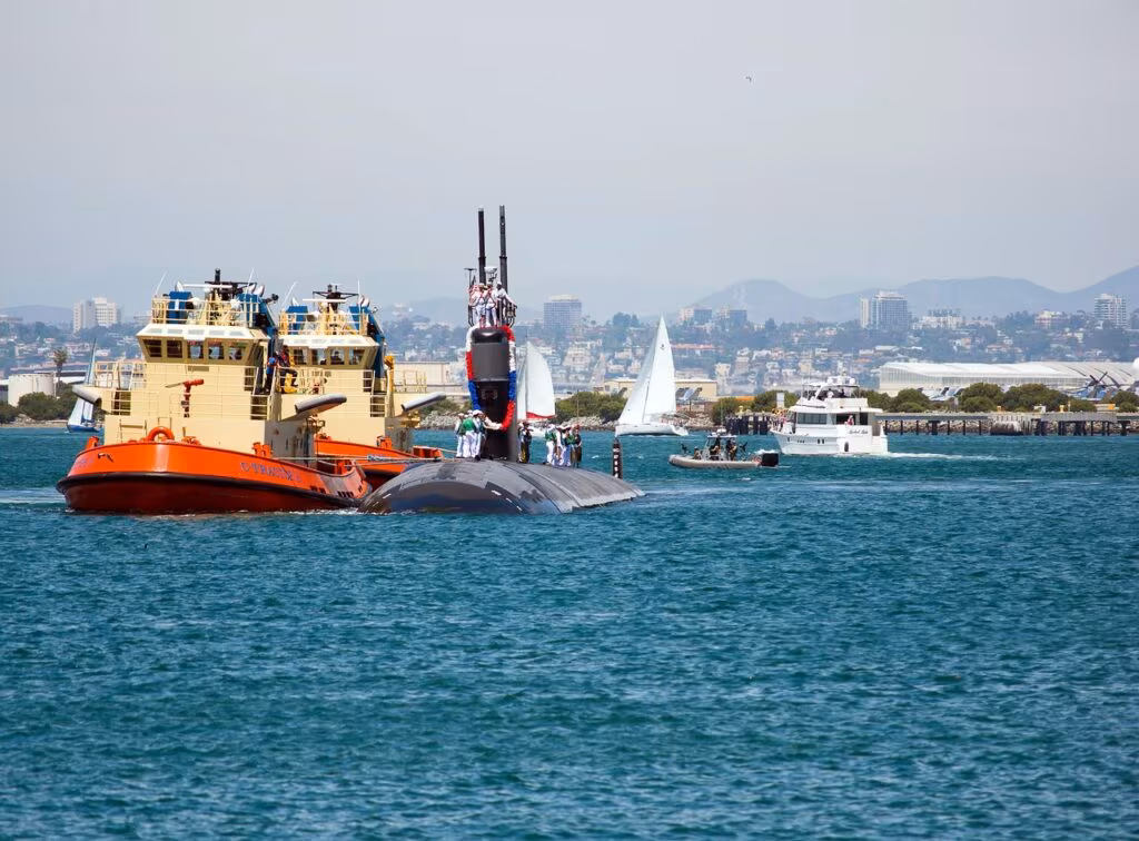 A large, modern nuclear-powered attack submarine (SSN) cruising on the ocean surface.