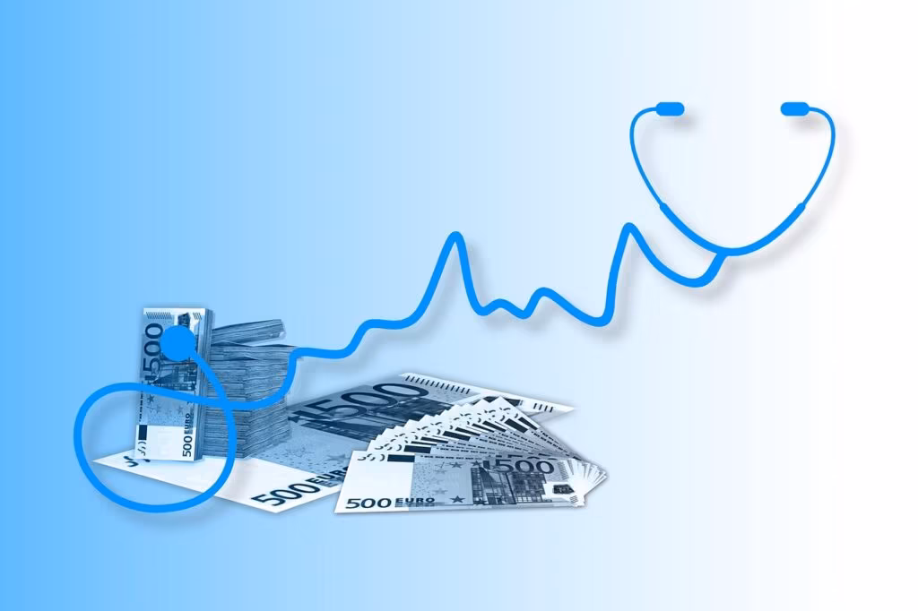 A person looking stressed while reviewing a large stack of financial and medical documents at a kitchen table.