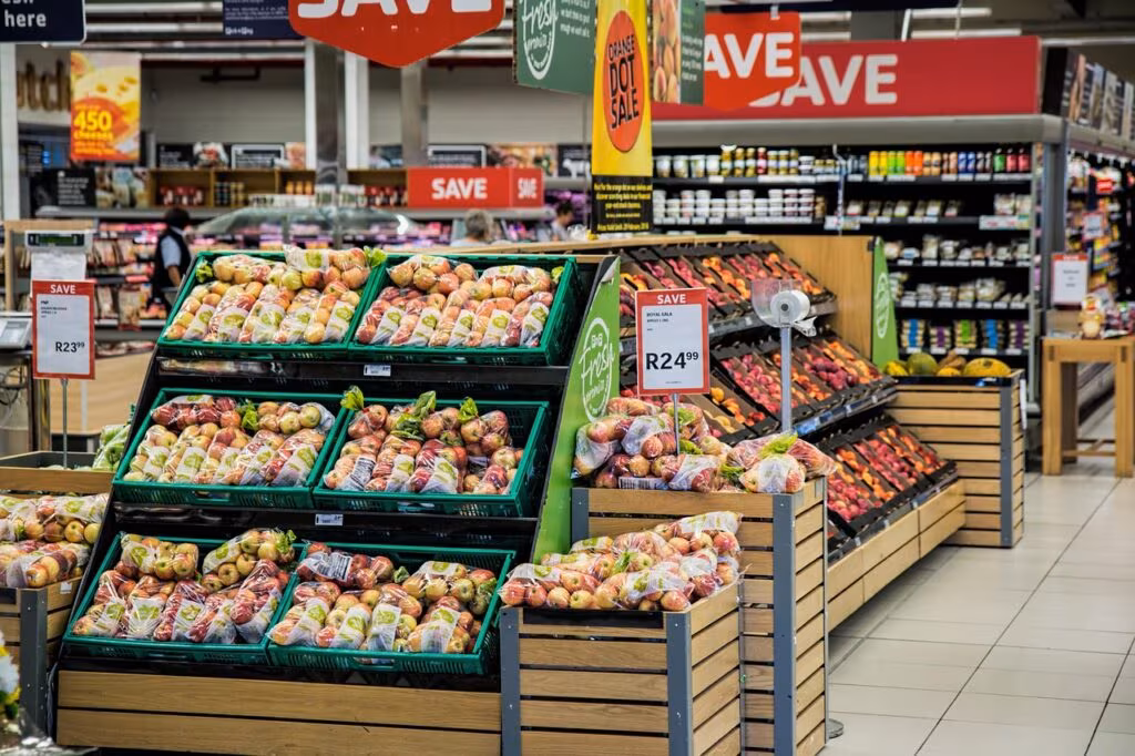 A person using an Electronic Benefit Transfer (EBT) card to pay for groceries at a supermarket checkout.