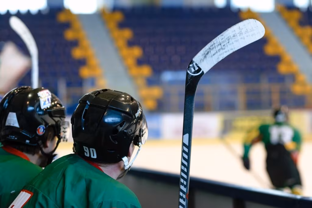 An American hockey player celebrating a goal during an international tournament.