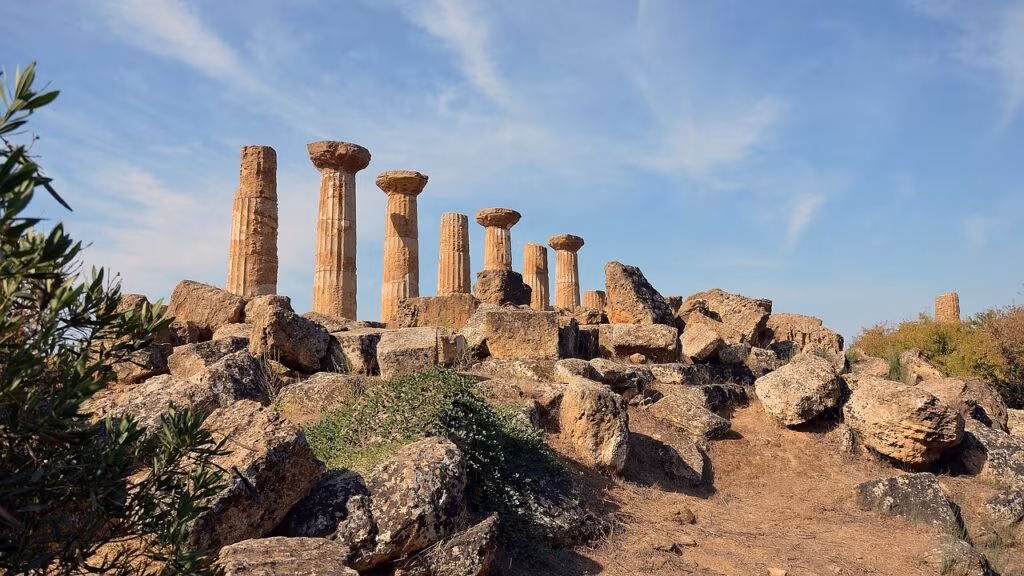 Artistic reconstruction of a Neanderthal man standing near an archaeological dig site in a cave.