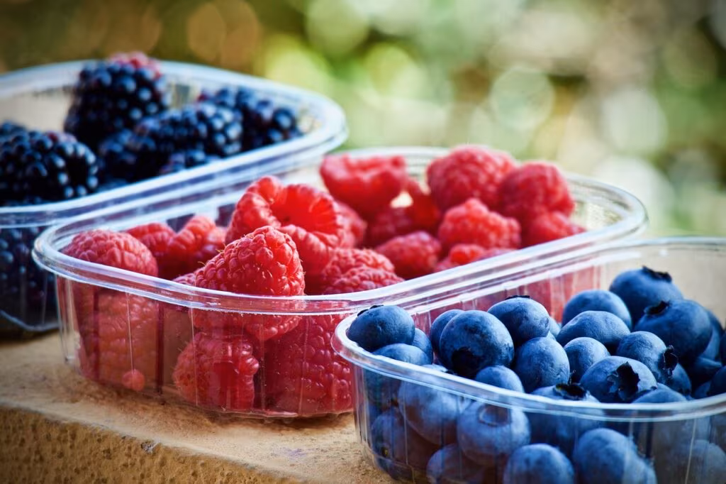 Close-up of fresh colorful raspberries, blueberries, and blackberries, rich in antioxidants