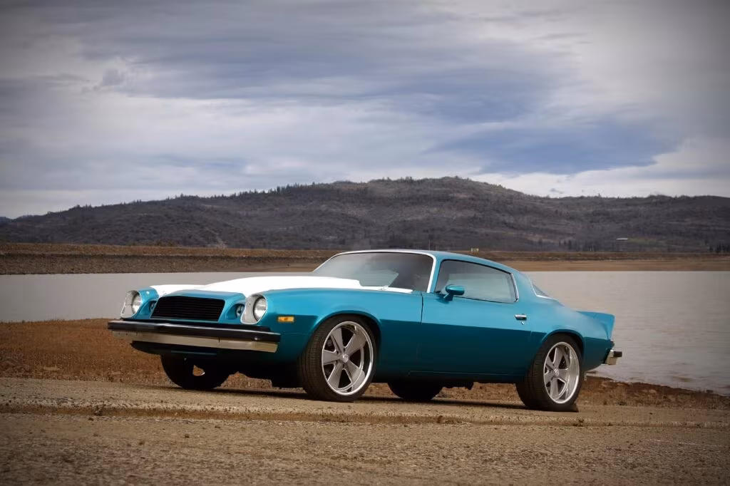 Close-up of the classic Chevrolet Camaro emblem featuring horizontal red, white, and blue stripes