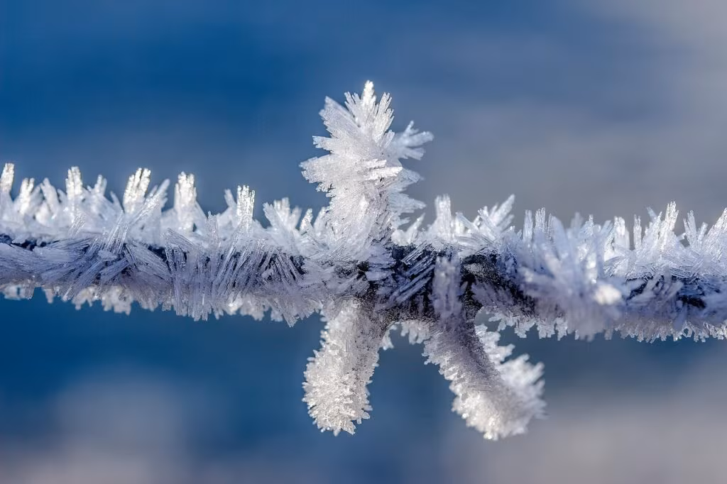 Conceptual illustration of icy planetesimals colliding in a cold, distant region of a young star system, leading to the formation of a debris disk.
