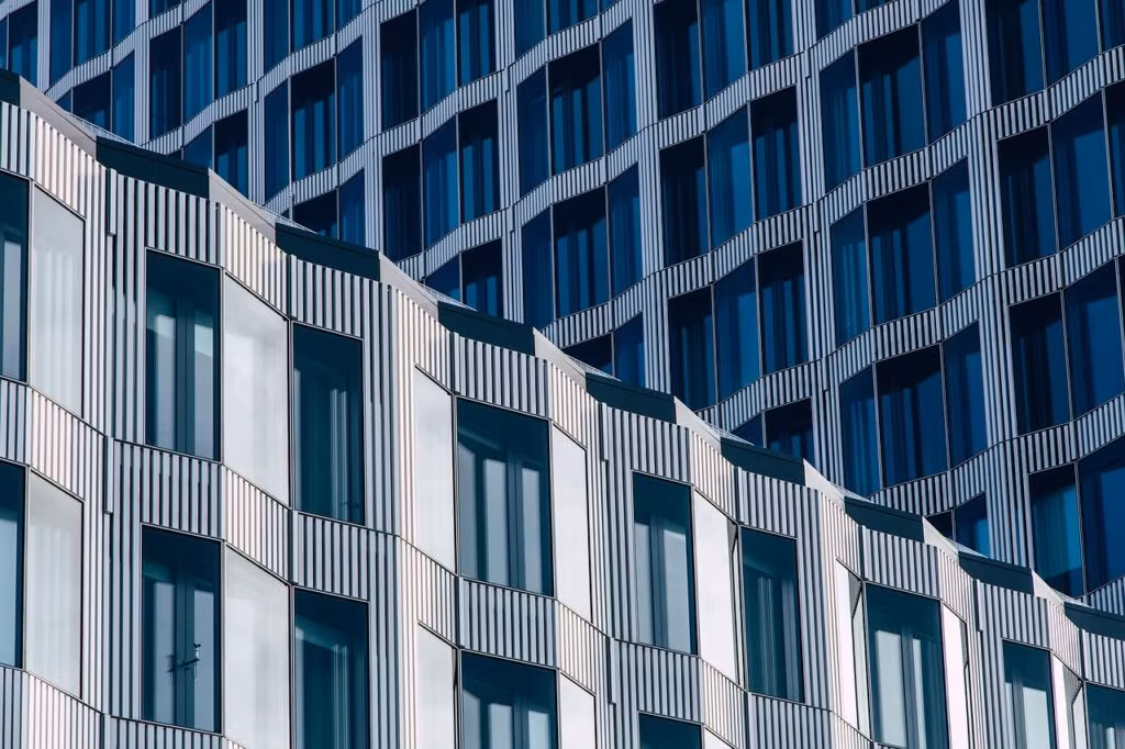 Modern glass facade of the Samsung headquarters building against a blue sky.