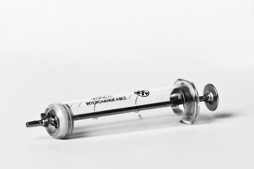 Pediatrician administering the MMR vaccine to a child in a sterile clinic environment