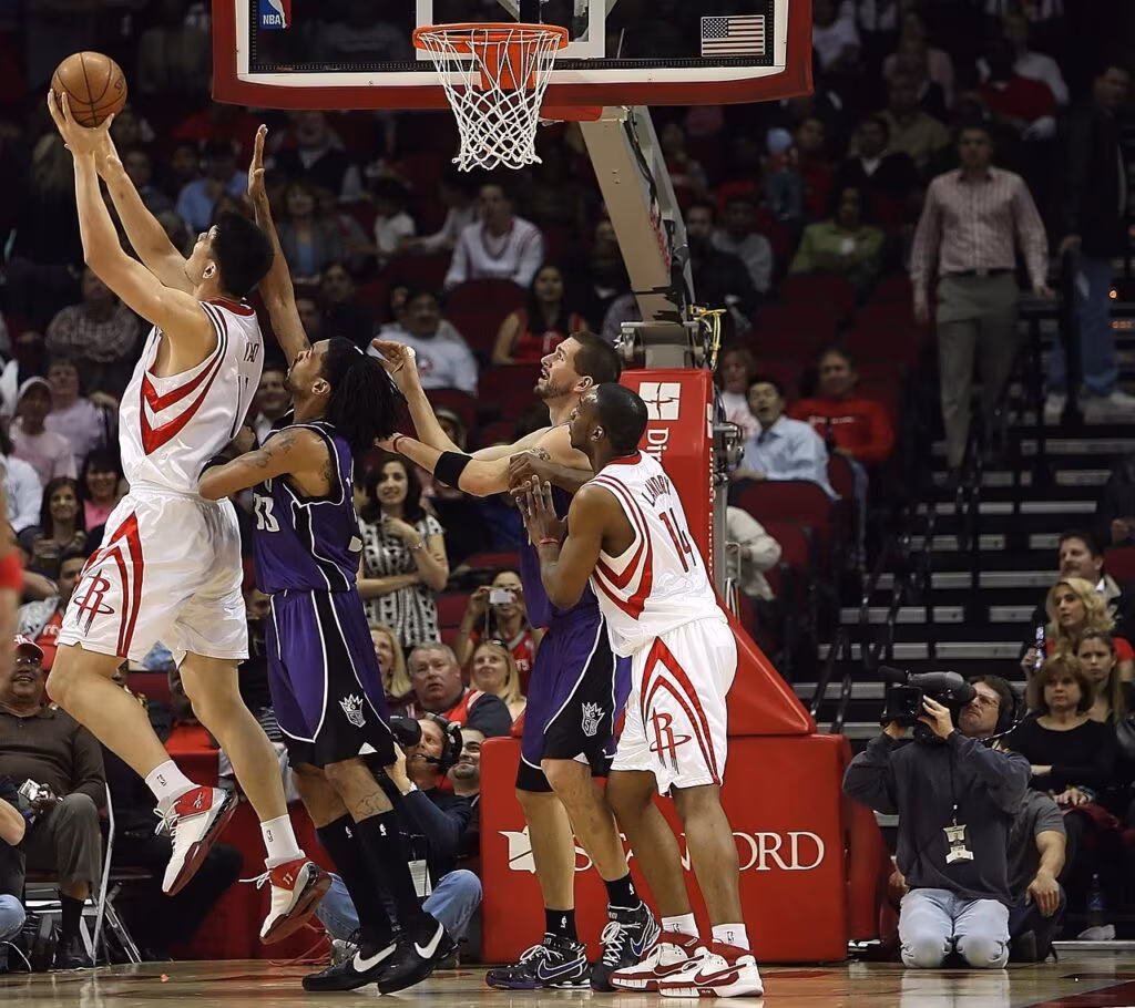 Professional basketball game in progress with players on the court and a large crowd in the background, focusing on the integrity of the sport.
