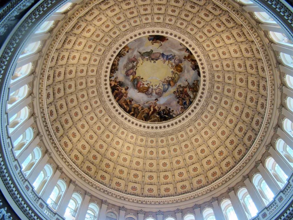 The US Capitol Building under dark clouds, symbolizing a political impasse and government shutdown.