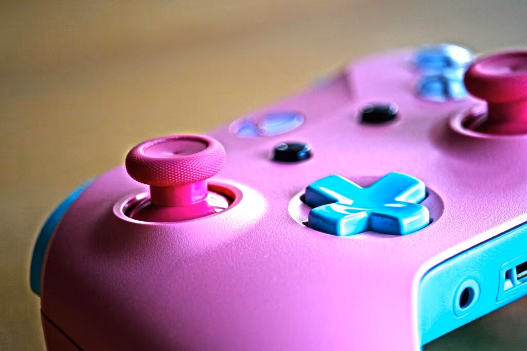 Xbox controller resting next to a laptop displaying the Microsoft 365 logo, symbolizing the affected services