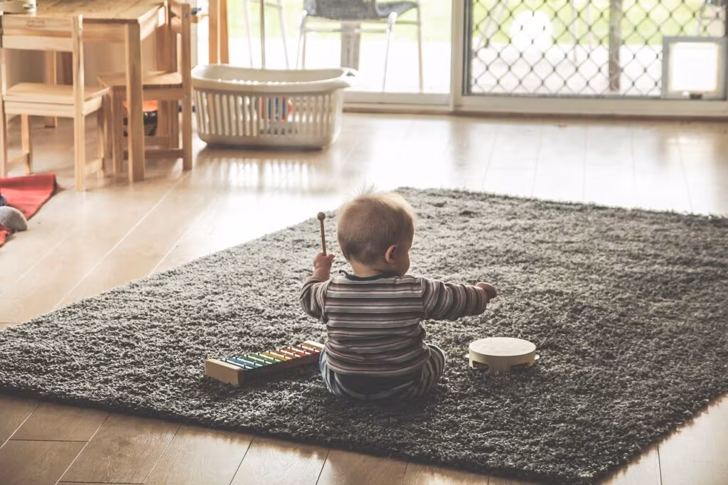 Young child playing with colorful building blocks, symbolizing early developmental milestones.