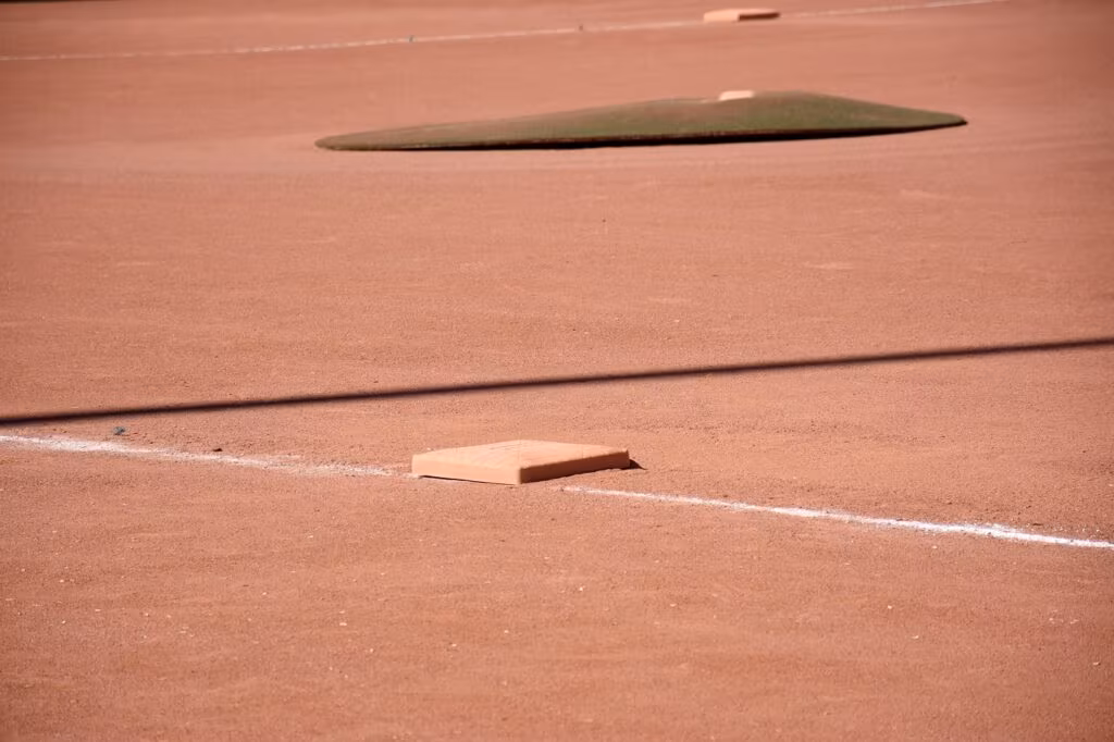 Youth baseball players running the bases on a sunny field