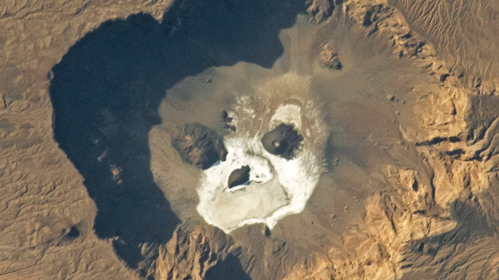 Glowering 'skull' stares upward from a giant volcanic pit in the Sahara — Earth from space - Live Science