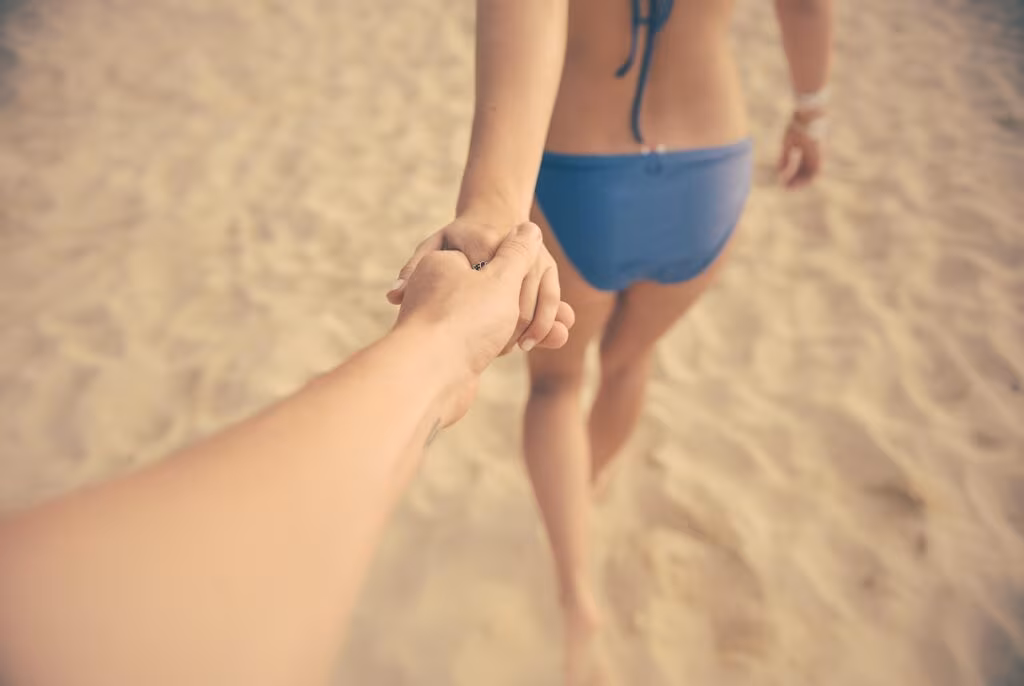 A couple holding hands in a gentle, patient manner, symbolizing relationship stability and trust.
