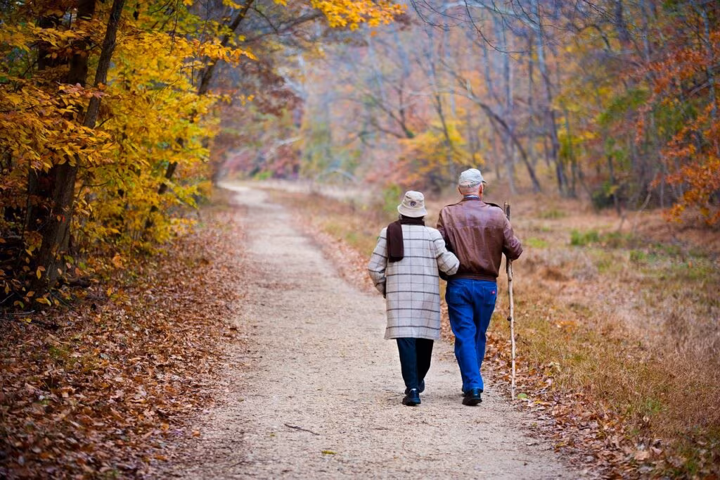 A couple holding hands in a peaceful, natural setting, representing patience and a strong relationship bond.