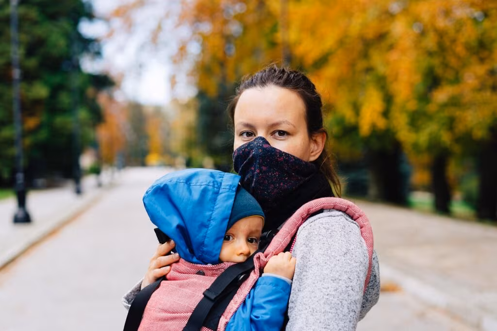 A family enjoying quality time together in an autumn park, emphasizing familial bonds.