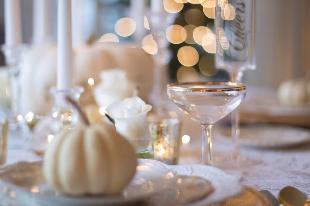 A family sitting around a Thanksgiving dinner table, engaging in polite conversation and smiling.