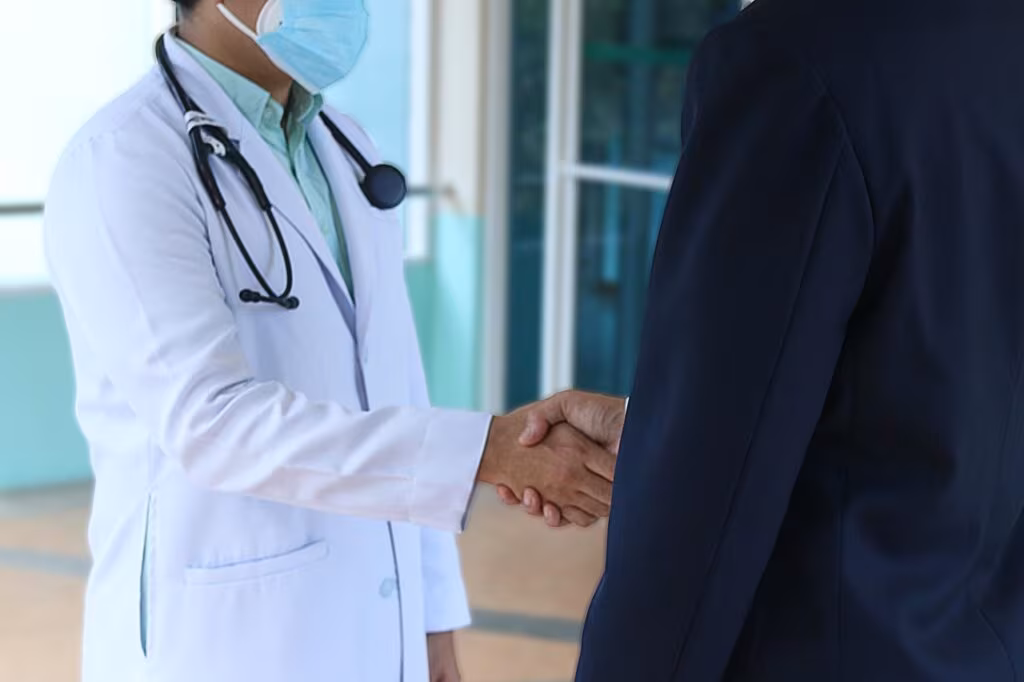 A genetic counselor reviewing test results with a female patient in a clinical setting.