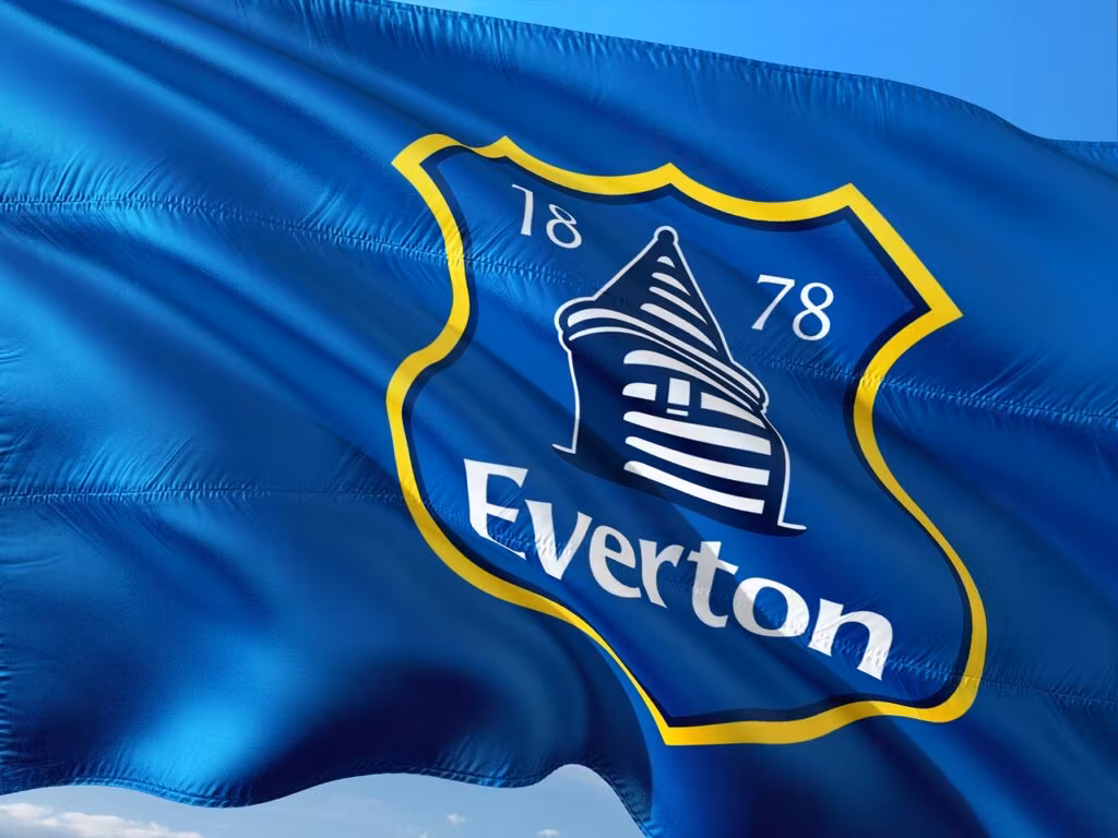 A manager looking disappointed on the sideline during a high-stakes Premier League match.