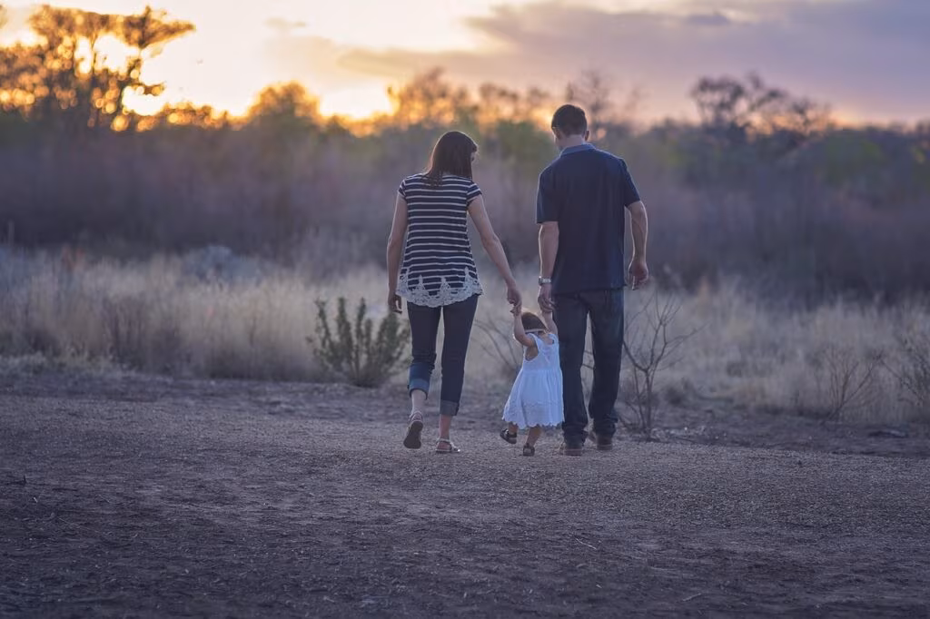 A peaceful autumn scene with a family walking through a park, emphasizing harmony and connection.