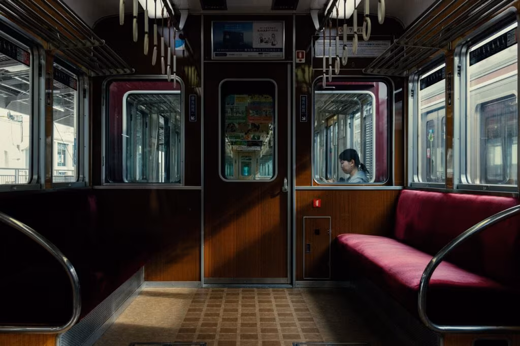 A person holding a mug of herbal tea, looking out a window during the morning, emphasizing a healthy routine.