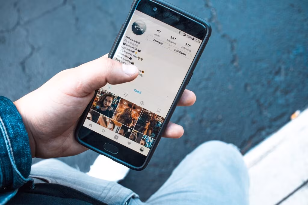 A person in India using a mobile phone to interact with an AI chatbot interface, emphasizing digital access.