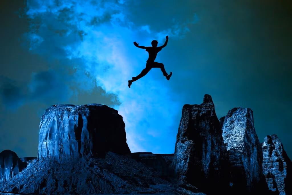 A person standing confidently on a mountain peak, symbolizing courage and determination.