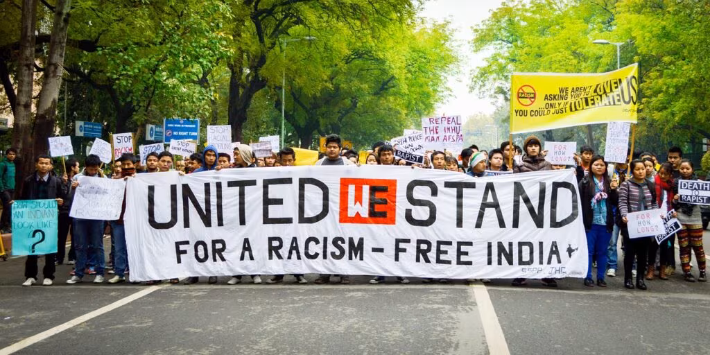 A political rally outside New York City Hall with protest signs, illustrating the political environment of the election