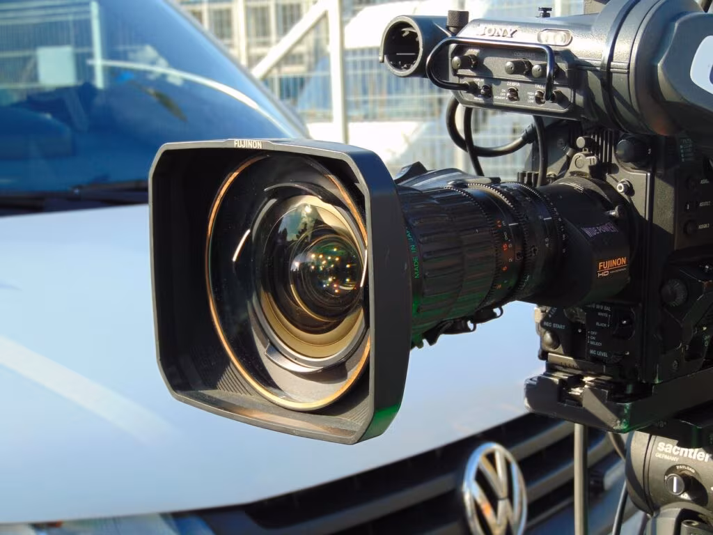 A professional television broadcast booth overlooking an NFL stadium, symbolizing the new role for Drew Brees at Fox Sports.