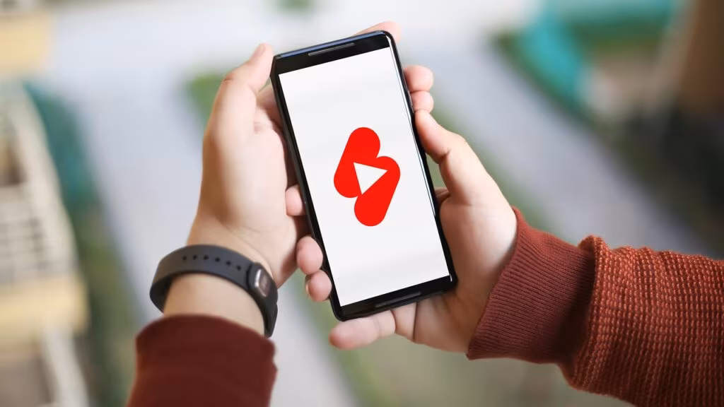 A streamer's setup displaying The Sims 4 gameplay on a monitor with a live chat overlay.