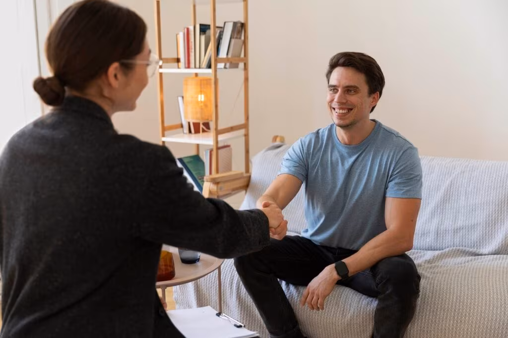 A therapist sitting across from a patient in a counseling setting, emphasizing the importance of human professional support.