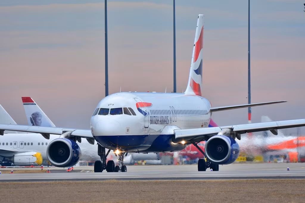 A traveler anxiously checking their phone for flight status updates at a busy airport terminal.