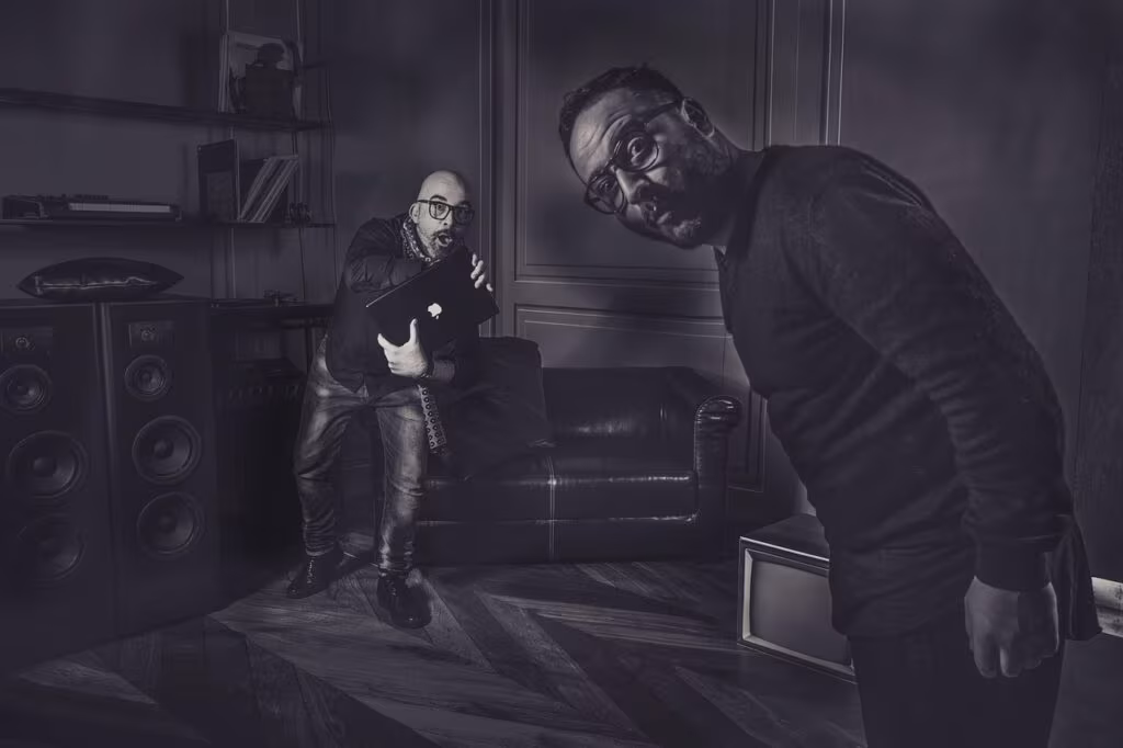 Backstage view of a television studio set with crew members preparing for a scene, showing monitors and equipment.