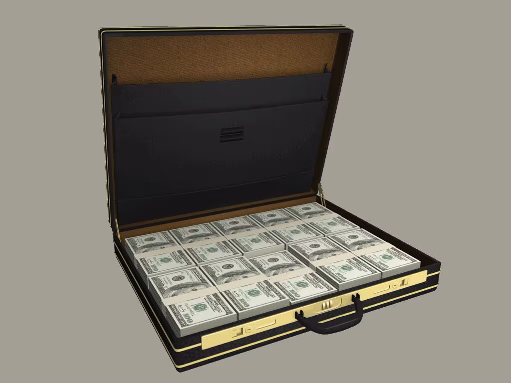 Close-up image of a money counting machine processing large stacks of hundred dollar bills