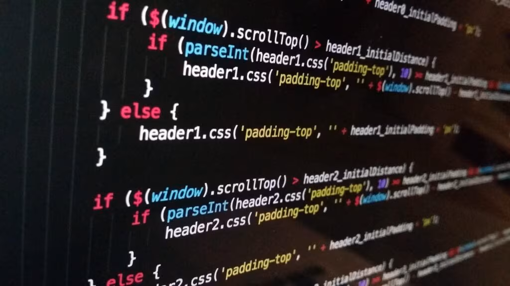 Close-up of a computer screen showing code and game development software, symbolizing the ongoing work on Hytale.