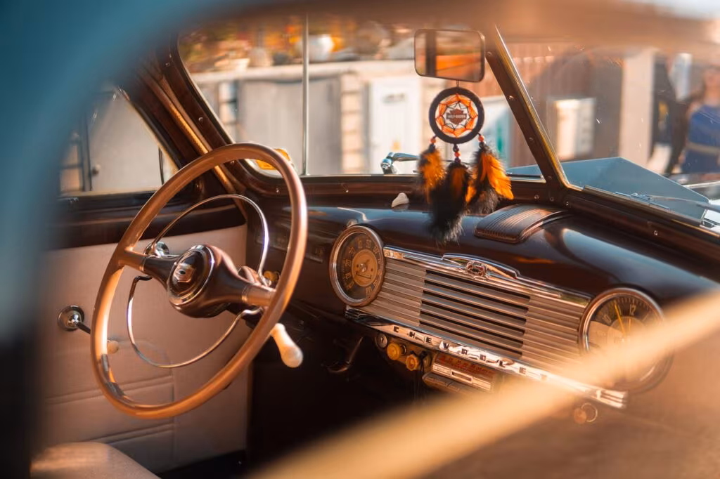 Close-up of a driver's hands lightly gripping a steering wheel while a Level 2 ADAS system is active.