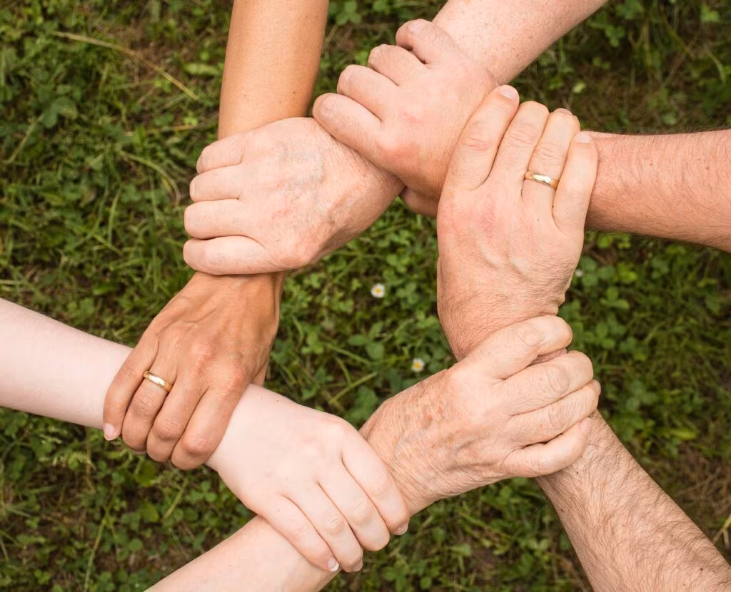 Close-up of a man and woman's hands gently intertwined, symbolizing trust and physical connection.