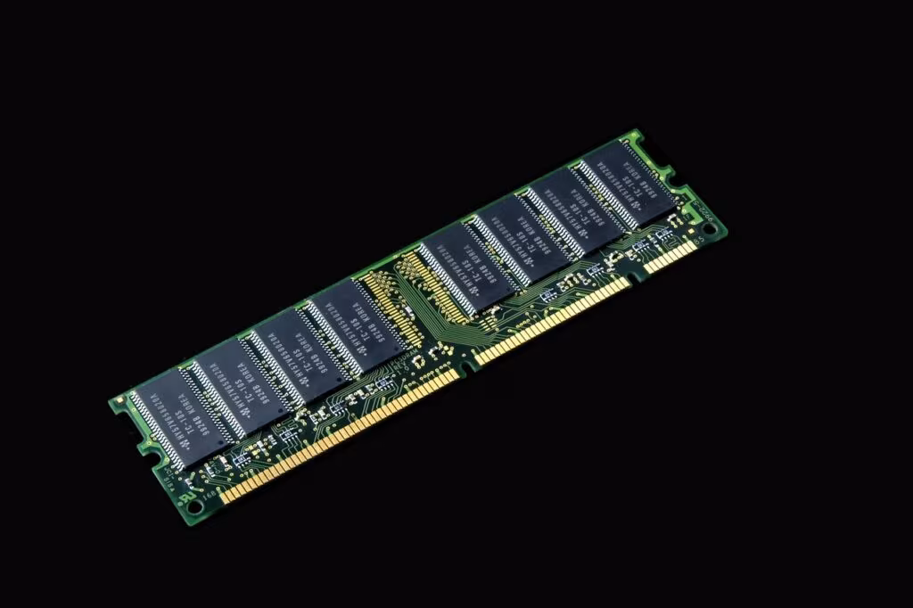 Close-up view of DDR5 RAM memory chips on a circuit board, illustrating the semiconductor shortage.