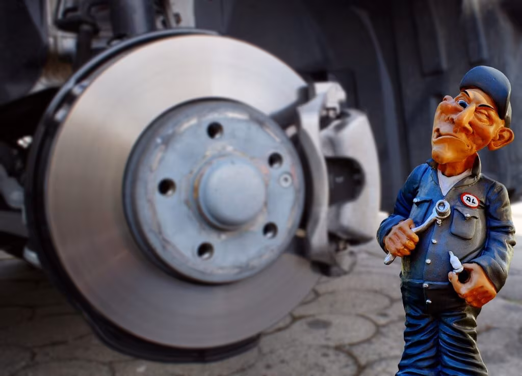 Close-up view of an electric vehicle brake caliper and rotor, highlighting the complexity of modern braking systems.