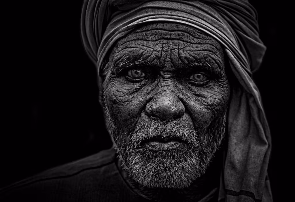 Detroit Lions Head Coach Dan Campbell on the sideline during an NFL game, showing intense focus.