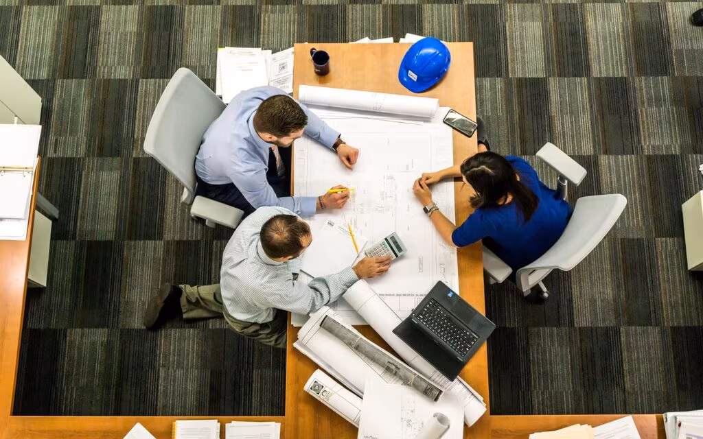 Executives reviewing corporate strategy on a large screen during a meeting.
