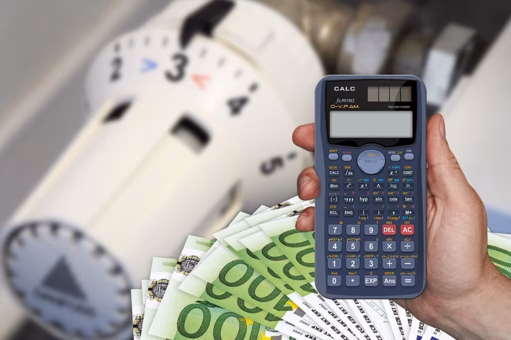 Financial calculator and pen on top of retirement savings documents