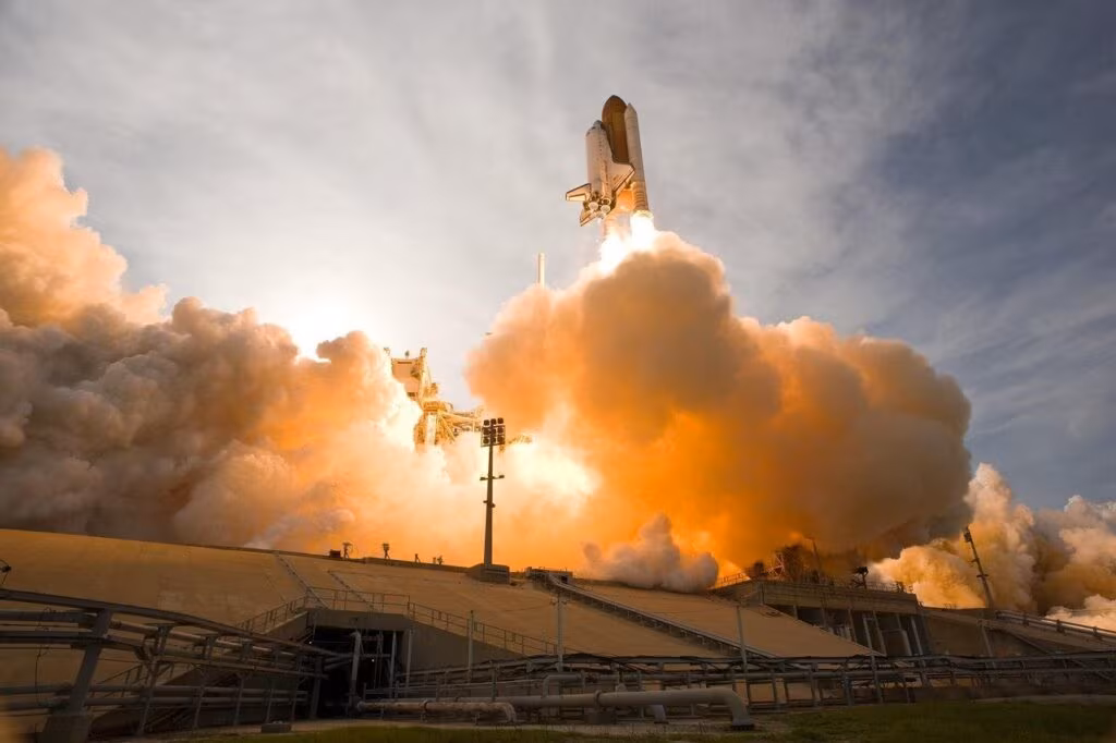 Illustration of a reusable rocket stage performing a vertical landing maneuver, demonstrating VTVL technology.