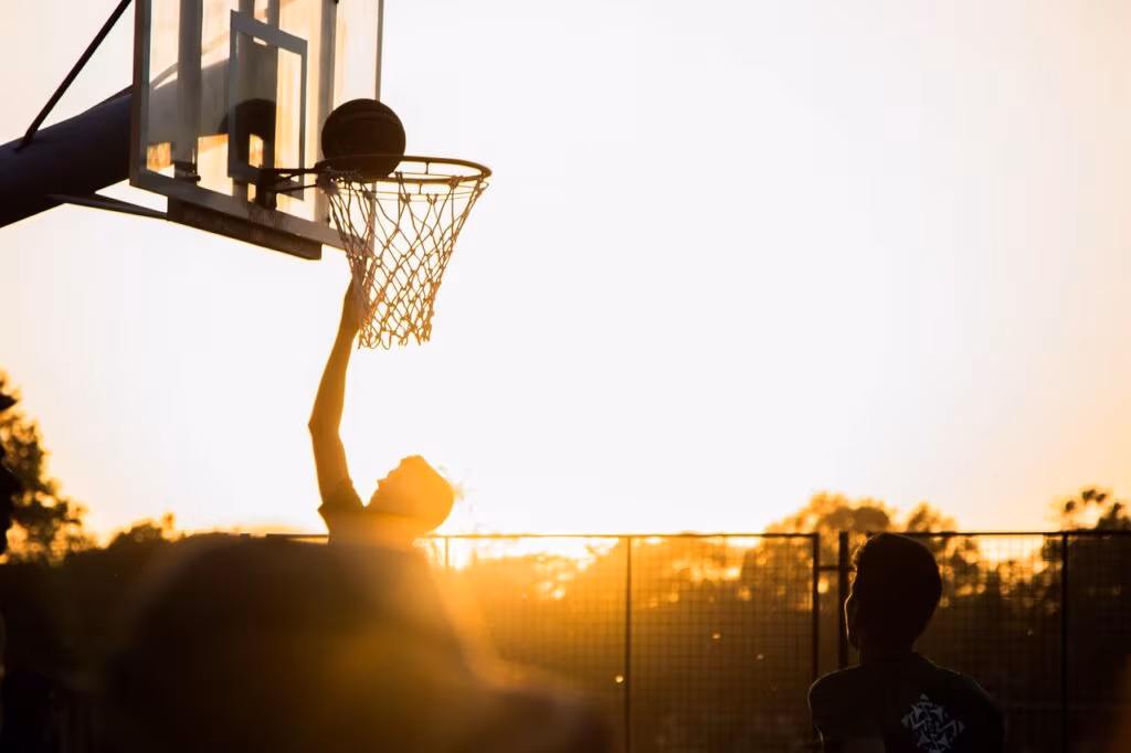 Intense action shot from the UNC vs Kansas college basketball game, highlighting the rivalry and high stakes.