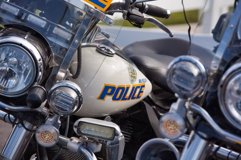 Nigerian police security patrol vehicle driving on a dusty road in a rural area, symbolizing the security challenges.