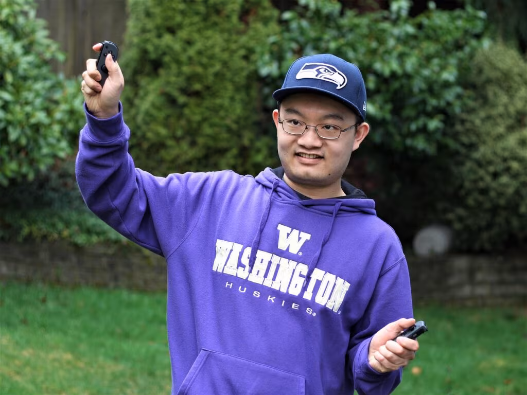 Nintendo Switch console with detached Joy-Con controllers and a game cartridge nearby.