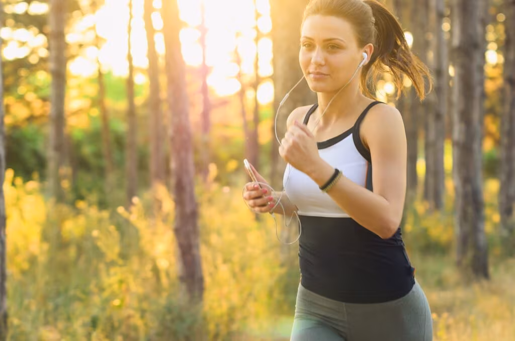 Older man jogging happily in a park, symbolizing healthy aging