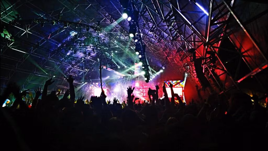 Olivia Rodrigo performing live on stage under bright lights