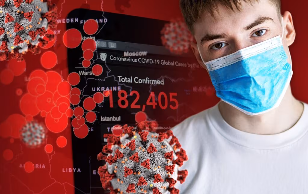 Person wearing a surgical mask while gently coughing, demonstrating caution with lingering respiratory symptoms.