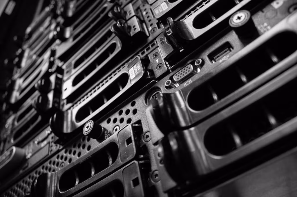 Rows of servers and computing hardware in a modern data center, symbolizing the massive infrastructure required for AI.